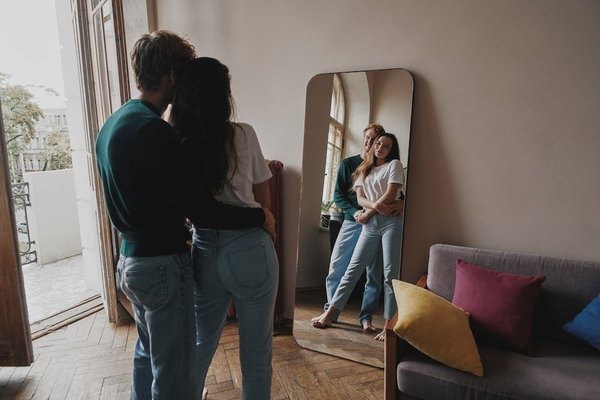 How can you effectively use mirrors to enhance the light in a Cornish cottage?